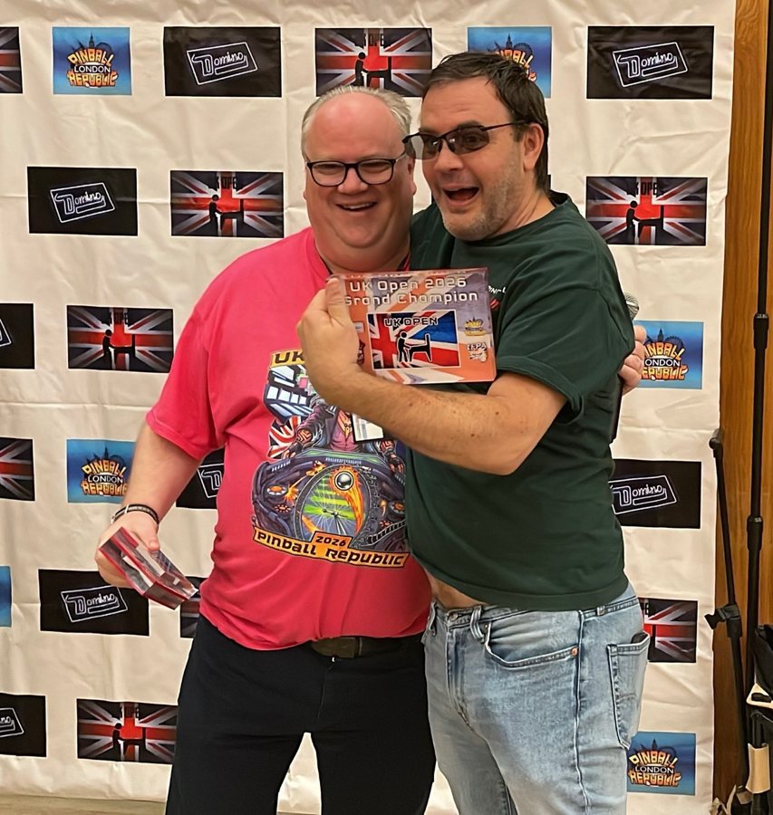 Eric Stone holding his UK Open 2026 Grand Champion card with organizer Neil McRae