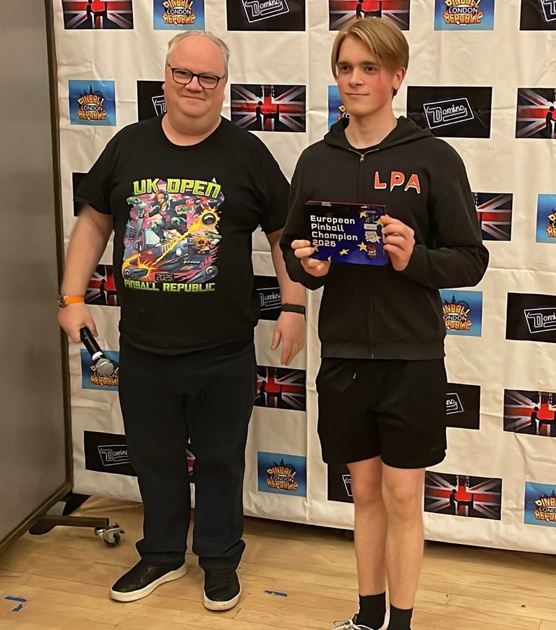 Viggo Löwgren holding his European Pinball Champion 2026 award with organizer Neil McRae